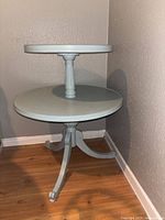 full view of two-tier robin blue wood table in corner