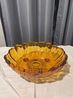 Top angle of amber sunflower footed bowl showing interior pattern and overall form