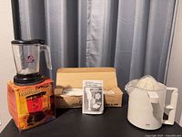 Overall lot showing Teavana Tea Maker, Braun juicer and Multi-Blend mixer box