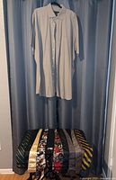 Synergy beige short-sleeve shirt on hanger, ten vintage neckties displayed underneath