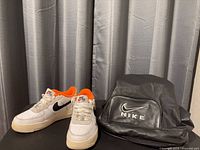 Pair of sneakers and backpack side by side