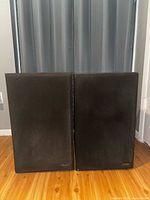 Front view of both Omega 400 speakers with grilles attached