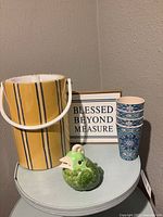 Full view of all items: ice bucket, cups, bird, and sign