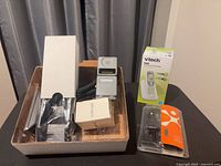Overview of lot showing Motorola phone in inner box, VTech CS6114 box, sealed Cingular charger