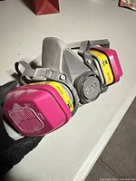 Front angled view showing 3M respirator and attached 60923 cartridges