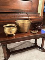 Group shot showing brass cauldron, brass bucket with handle, two ceramic pots on piano bench