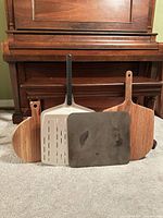 Front view showing all four items upright against piano