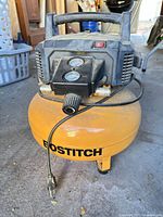 Front view showing Bostitch logo, gauges and power cord