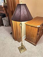 Full view of brass floor lamp with shade