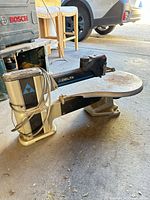 Side view showing entire Delta scroll saw with logo, base and table
