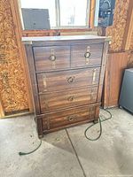 Front view showing all drawers, hammered pulls, metal corner brackets