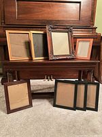 Eight assorted frames displayed; top row four tabletop/hanging, bottom row four hanging only
