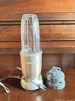 Motor base with cup attached and power cord visible