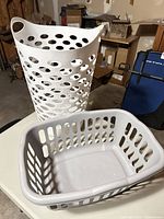 Both hampers on table in garage
