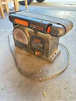 Left front view showing WEN label, 6" disc guard, power switch, belt housing