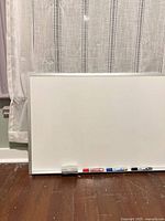 Large whiteboard with eraser and markers on tray