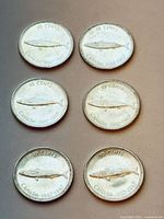 Six 1967 Canadian 10-cent coins, obverse sides up