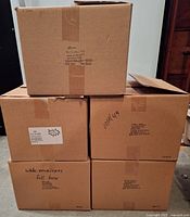 Five sealed cardboard boxes labeled white envelopes
