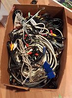 Box filled with mixed cables showing various connector types