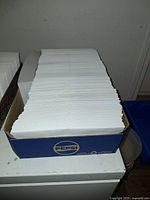 Flat of white regular business envelopes in Pepsi box