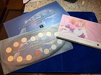 Millennium Canada coin set with Breast Cancer coin card on blue cloth