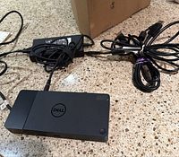 Docking station connected to Dell power adapter and host cable