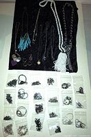 Overview of loose jewelry pieces and sealed bags