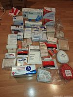 Overall view of all first-aid supplies laid out on floor