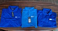 Three unfolded blue polo shirts showing logo and Ogio tag