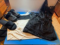 Group shot of all garments and slippers on blue background