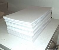 Stack of loose legal-size white paper on tabletop