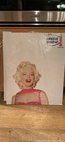 Upper panel showing Marilyn Monroe’s head and torso in wrap