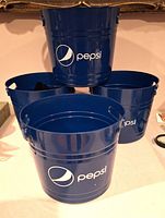 Four blue Pepsi waste cans stacked and displayed