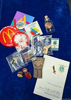 Group view of all pins and bottle