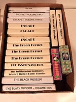 Box filled with labeled cassette cases for Escape, The Green Hornet, Inner Sanctum, The Black Museum, Smithsonian Institute Science Fiction Radio Classics