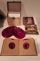 Open carry case, two boxed sets, several red vinyl discs, open binder album