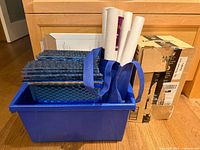 Lot overview showing blue bin with bubble mailers, tubes, envelopes and box