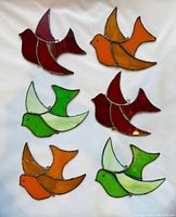All six stained glass bird suncatchers in assorted red, orange, green colors