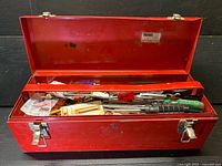 open red toolbox showing tools and hardware