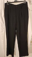Front view of Armani black pleated pants on hanger