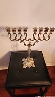 Front view of silver-plate menorah with eight candle cups