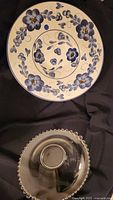 Top view of both bowls showing ceramic floral design and glass beaded rim