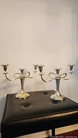 Pair of matching silver-plated three-arm candelabras