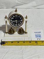 Front view showing entire clock with tape measure for scale