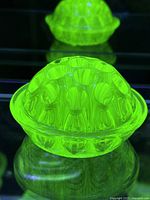 Top view of glowing uranium glass flower frog showing perforations