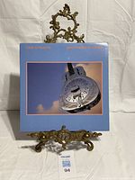 Front cover of Brothers In Arms LP on stand