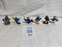 Group shot of all five Smurf figures standing in a row