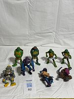 Overview of eight TMNT figures laid on white cloth