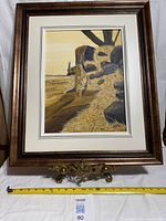 Full view of framed painting on stand