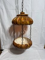 Full view of hanging ceramic swag planter lamp on chain